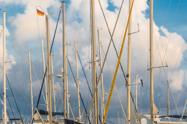 White boat and yacht masts with rigging on a blue sky background of Mallorca island. Spain