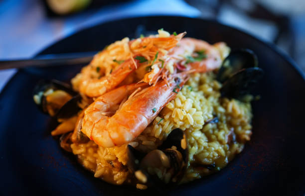 istock Seafood. Risotto with seafood on a table in a restaurant. 1692753915