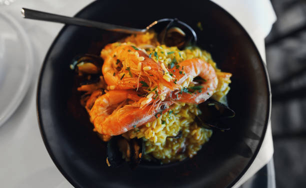 istock Seafood. Risotto with seafood on a table in a restaurant. 1692753918