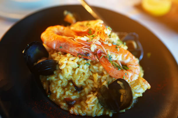 istock Seafood. Risotto with seafood on a table in a restaurant. 1692753924