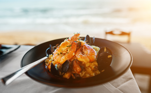 Seafood. Risotto with seafood on a table in a restaurant.