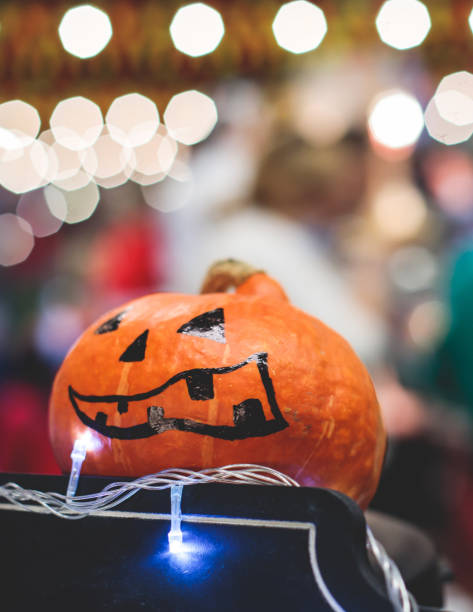 istock Process of making pumpkin lantern for halloween party, glowing jack-o-lantern carving master class on halloween fair market, orange decoration, illuminated carved pumpkin lanterns 1692784490