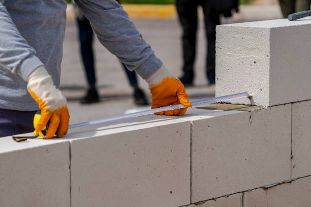 istock The bricklayer works to measure. Measuring with a meter 1692787126