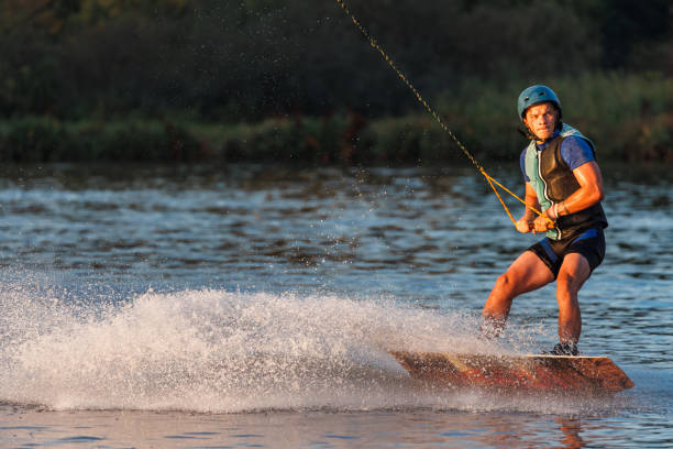 istock An athlete performs a trick on the water. Park at sunset. Wakeboard rider 1692796112
