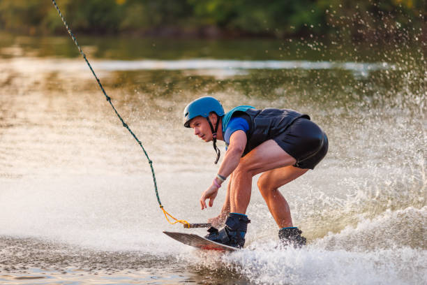 istock An athlete performs a trick on the water. Park at sunset. Wakeboard rider 1692796672