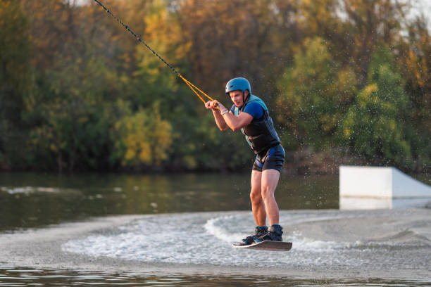 istock An athlete performs a trick on the water. Park at sunset. Wakeboard rider 1692798438