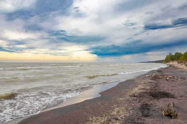 Dramatic clouds grace the skies at Long Point Provincial Park Beach on the shore of Lake Erie, Ontario.