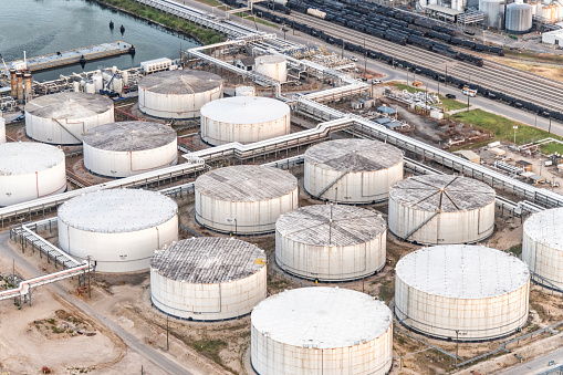 A group of fuel storage tanks in oil refinery in Houston, Texas located along the Houston Ship Channel about 5 miles east of downtown shot via helicopter from an altitude of about 600 feet.