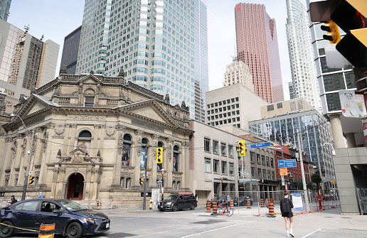 Toronto, Canada - August 21, 2023: View from the southeast corner of Front Street and Yonge Street in downtown. The historic Hockey Hall of Fame stands at 30 Yonge Street. Modern office towers stand in the background. Summer morning in Canada's largest city.