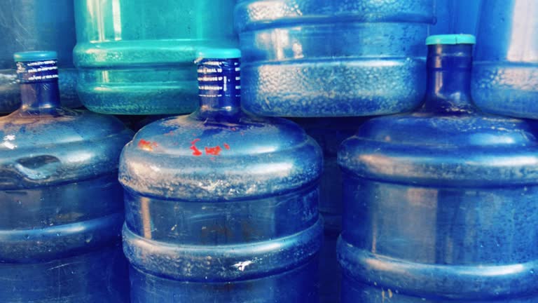 Stacks of water containers waiting to be refilled with safe fresh clean drinking water in the Philippines.