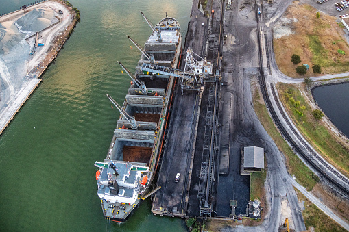 An international bulk carrier cargo ship in port being loaded with coal along the Buffalo Bayou on the Houston Shipping Channel about 4 miles east of downtown Houston, Texas.