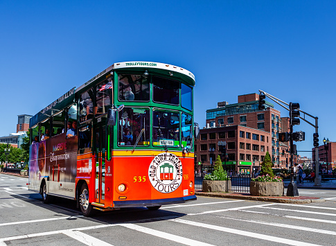 Boston, Massachusetts, USA - September 17, 2023:   A Boston tourist tour bus driving down Congress Street in downtown Boston, near Quincy Market.