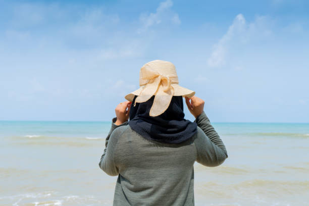 istock muslim woman standing on the beach 1692933377