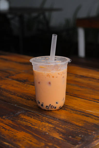 istock Thai tea with boba in a plastic cup on a cafe table. 1693017149