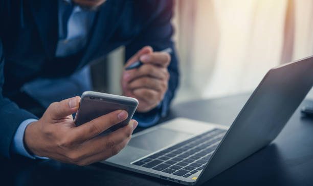 istock Business man use smartphone with laptop computer at office artificial intelligence technology global iot providing virtual, customer support and information. 1693023932