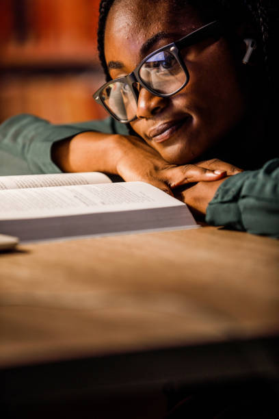 istock Overworked student leaning against the table in the library, pondering while studying late at nigth 1693026862