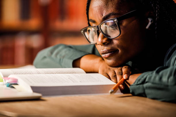 istock Tired student leaning her head on the table while studying at the library late at night 1693026863