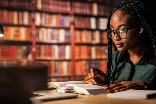 istock University student sitting at table at the library and studying for exam late at night 1693027156