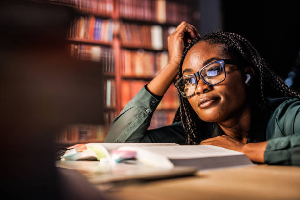 istock Tired university student leaning against her desk when studying for a long time late at night 1693027186