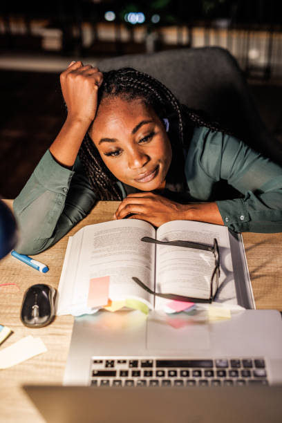 istock Tired studnet leaning against head against hand and taking a break from studying for exam 1693027445
