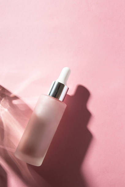 istock Cosmetic bottle  with glow serum on pink background with shadow,Flat lay copy space 1693029872