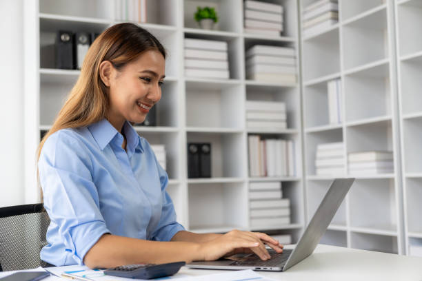 istock Asian female financial accountant working checking financial documents at home must use calculator to calculate before paying tax receipt online. Business budget planning 1693041729