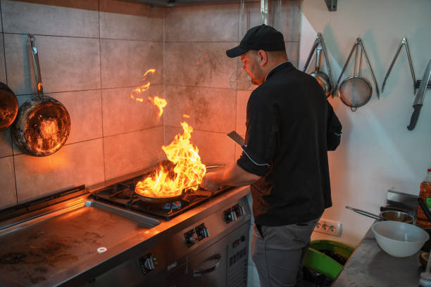 istock Caucasian Chef Flaming Meat at a Small Kitchen 1693042910