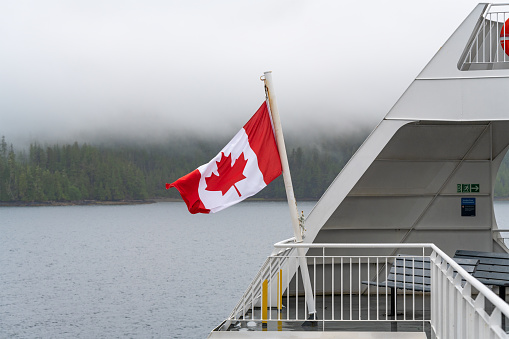Canadian flag on ferry boat along Inside Passage Cruise, British Columbia, Canada.