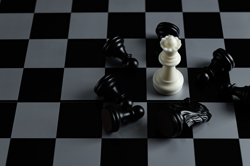 Pieces on chess board on black background for playing game and strategy.