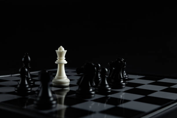 istock Pieces on chess board on black background for playing game and strategy. 1693087567