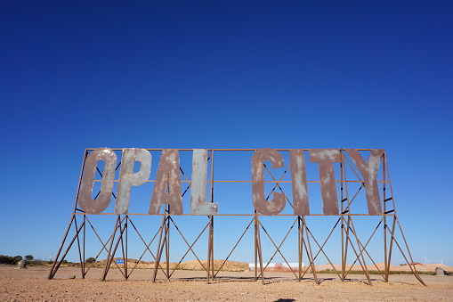 large metal sign saying Opal City at opal mining underground town Coober Pedy, South Australia, Australia