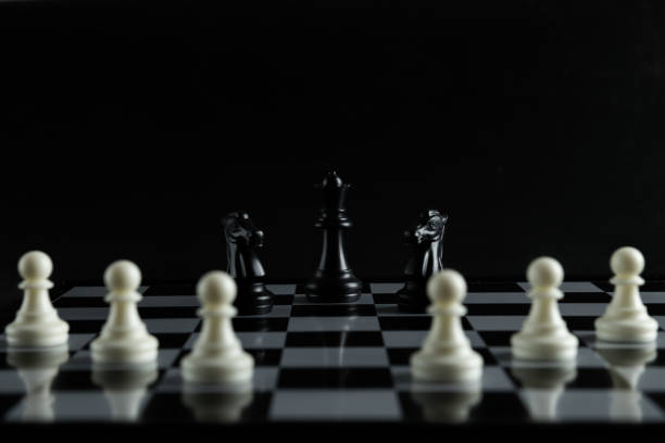 istock Pieces on chess board on black background for playing game and strategy. 1693089204