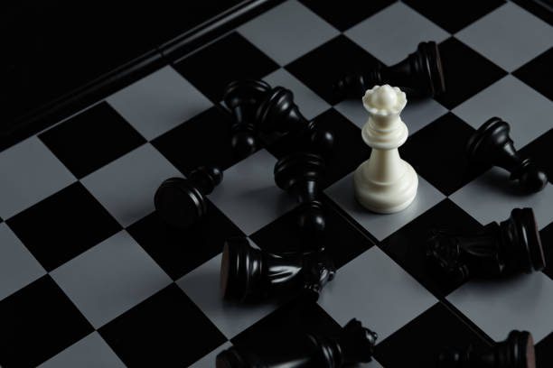 istock Pieces on chess board on black background for playing game and strategy. 1693092526