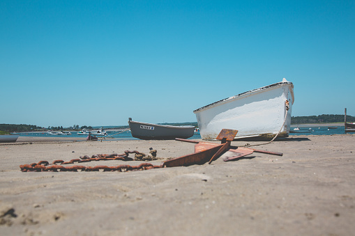 Boats on ocean beach during low tide