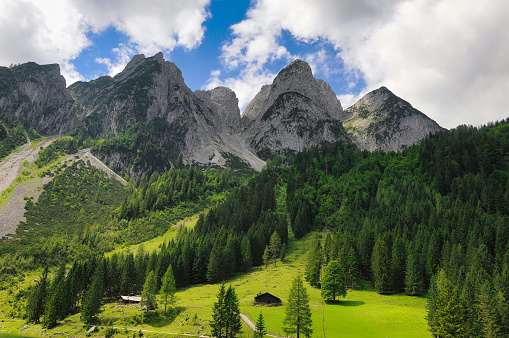 Hike along the Gosausee (Dachstein area - province of Upper Austria) with a view of the imposing mountain massif of the Gosaukamm.