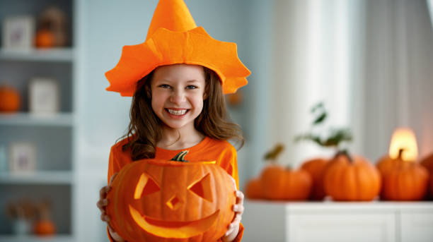 istock girl with carving pumpkin 1693194519