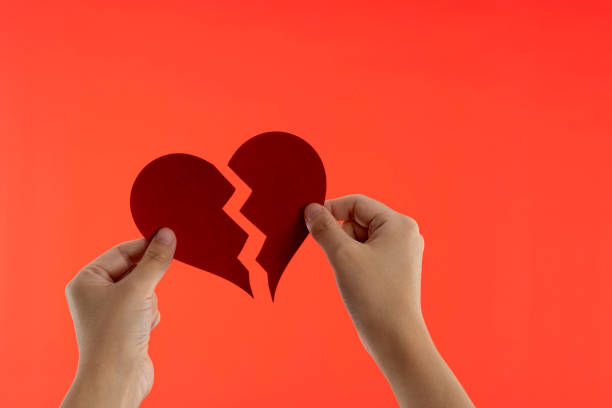 istock Woman hands holding broken heart 1693202344