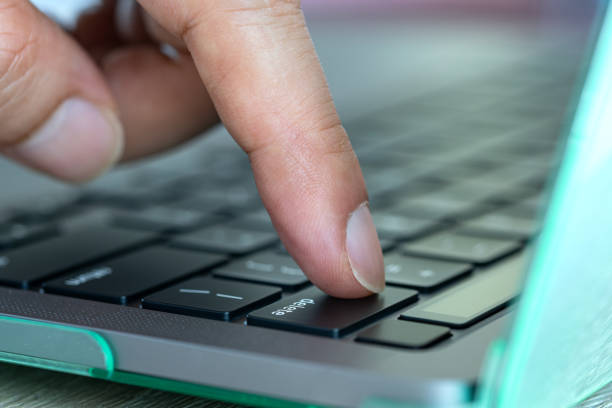 istock Finger of the computer user, he presses the delete button on the computer keyboard 1693213124