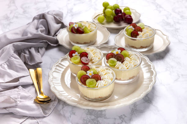 istock Delicious cheesecake with grapes and whipped cream on marble board 1693215135