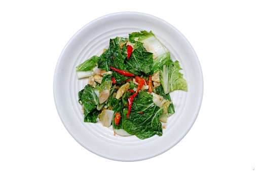 Stir fry Chinese cabbage, stir fry Napa cabbage, tumis sawi putih  served on white plate on isolated background. Stir fried Chinese cabbage, stir fried Napa cabbage