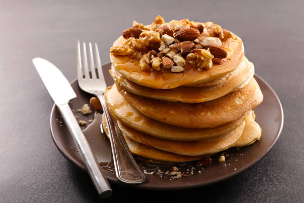 istock Homemade american pancakes with dried nuts and syrup 1693241138