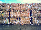 Crushed cardboard packaging ready for transport local landfill London England