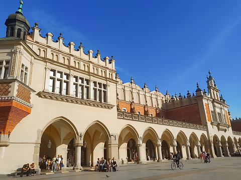 Krakow, Poland - May 22, 2023: People going at Main Market Square in Krakow in a summer day, Poland