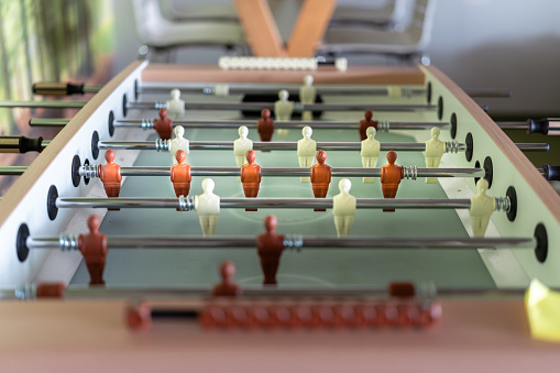Foosball table. Office game. Game  players. Play room interior.