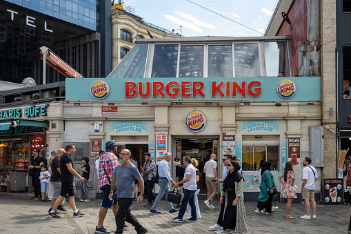 Istanbul, Turkey - September 23, 2023:Burger King branch on Istiklal Street in Istanbul and the crowd walking in front of it.