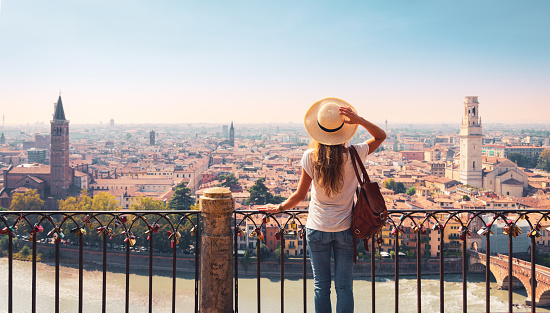 Traveler woman looking at panoramic view of Verona city- trave, tour tourism in Italy