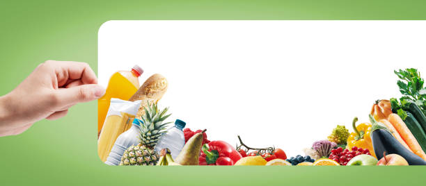 istock Hand holding a sign and assorted groceries 1693326855