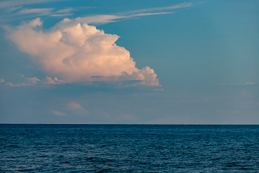 Clouds in the blue sky over the sea. Nature composition.