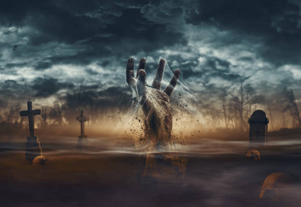 istock Zombie rising from the grave in the cemetery 1693331857