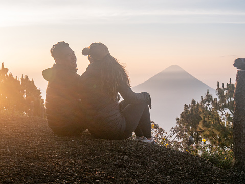 They enjoy nature at sunrise, looking at the beautiful landscape. Volcan Acatenango, Guatemala